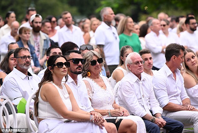 Luke Davies' mother (centre) with family and friends during Luke Davies' memorial service at New Farm Park in Brisbane.