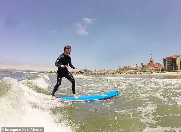 The soccer coach tries his hand at surfing in an Instagram photo