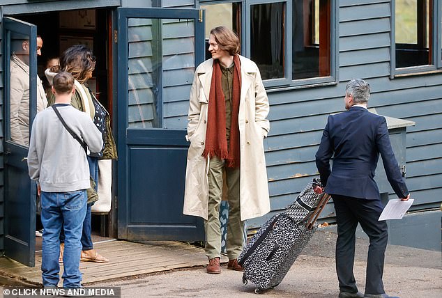 David looked dapper in a beige trench coat, paired with khaki chinos and brown shoes.