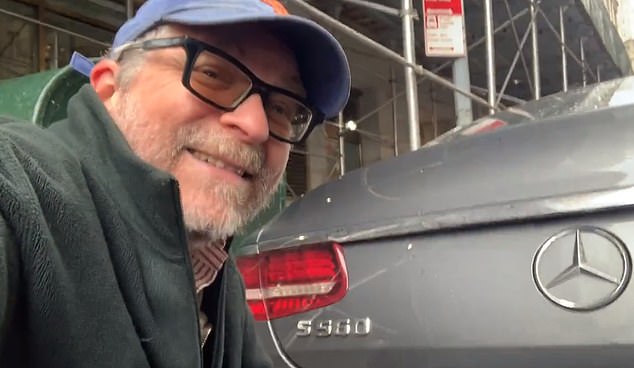 Gersh Kuntzman films himself fixing the license plate of a Mercedes in downtown Manhattan