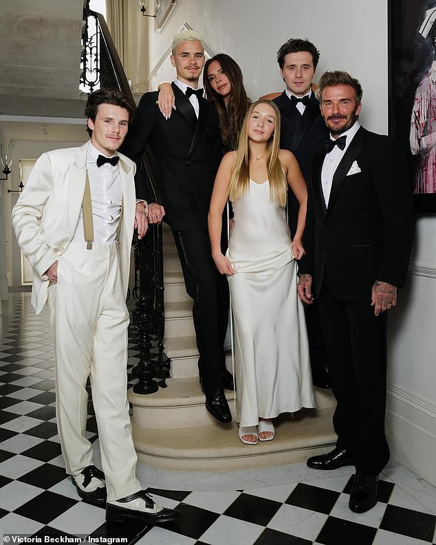 The Beckham clan can be seen posing on the stairs of their London home in an image shared on Instagram (LR: Cruz, Romeo, Victoria, Harper, Brooklyn and David Beckham)