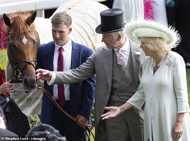 Charles pets Desert Hero, who won the King George V Stakes at Royal Ascot last year