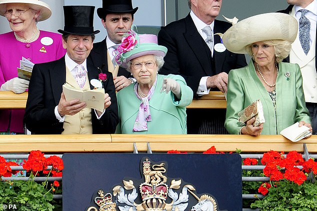 Queen Elizabeth II and Camilla watch horses in the Parade Ring at Royal Ascot in 2013