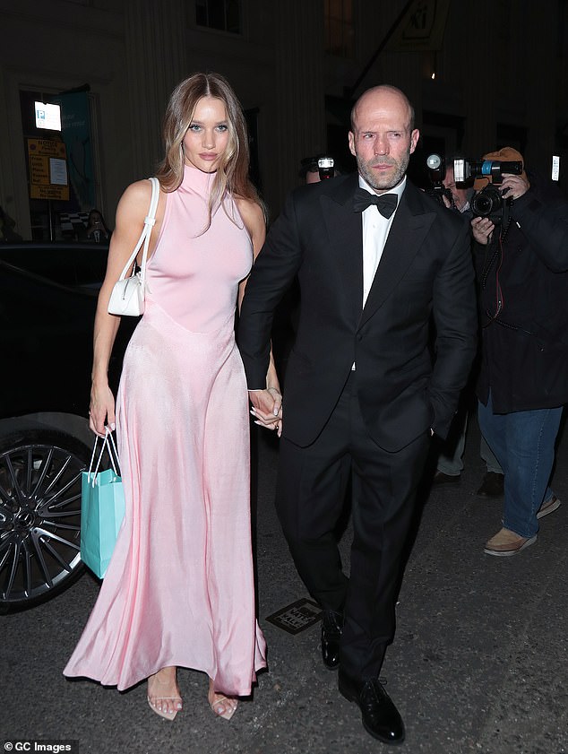 The 37-year-old model was the epitome of elegance as she stepped out in a pretty sleeveless pink silk dress that featured a high turtleneck and flowy skirt.