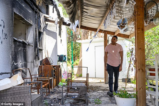 Torres looks at a destroyed house at Kibbutz Nir Oz on April 1, 2024 in Nir Oz, Israel