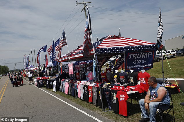 Vendors selling hats, flags and T-shirts lined the parking lot outside the rally site.