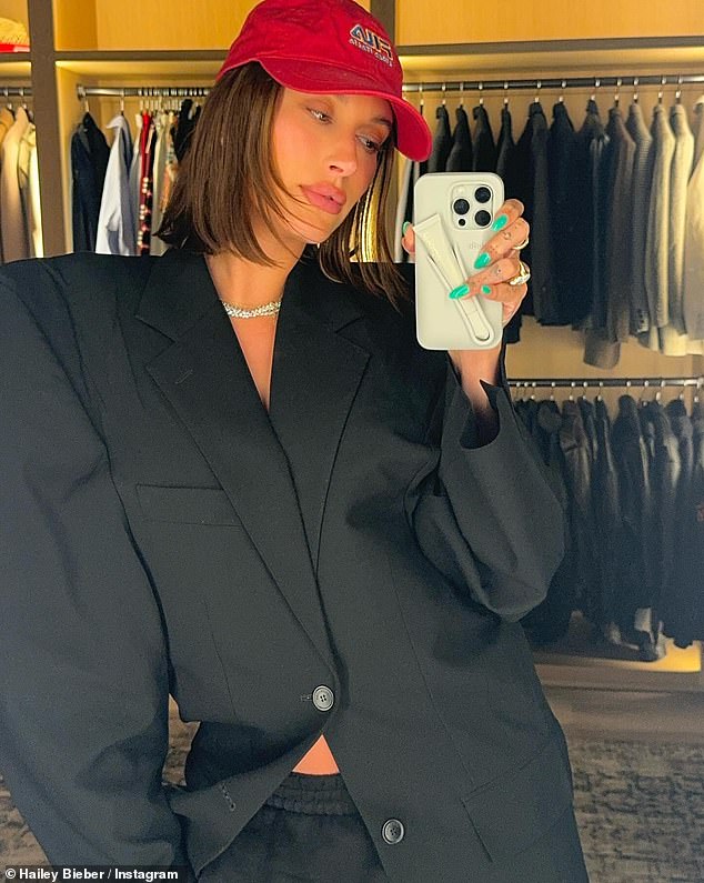 She also shared a mirror selfie wearing the same jacket and diamond necklace.  In the photo of her, she paired the jacket with a pair of black sweatpants and a red baseball cap as she posed in her closet.