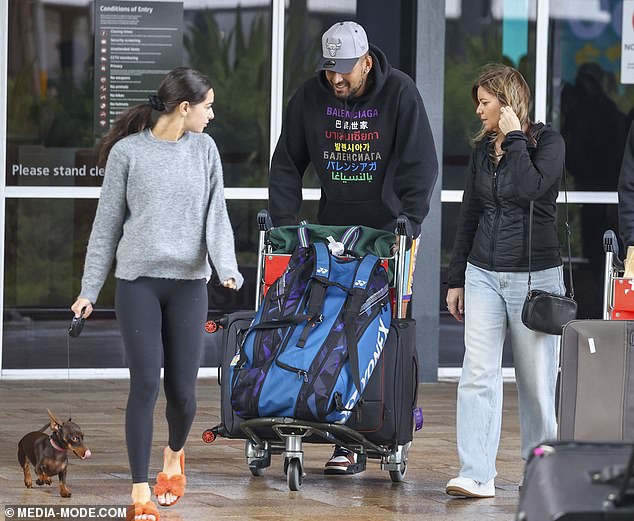The tennis star dressed casually in blue shorts and a black jumper as she pushed the couple's luggage through the airport.