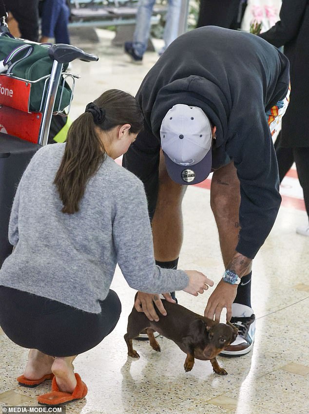 The couple seemed in high spirits as they were greeted by their nearest and dearest, including their dog Boo, who was waiting for them at the arrivals terminal.