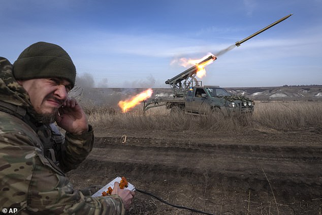 A Ukrainian officer from the 56th Mariupol Separate Motorized Infantry Brigade fires rockets from a pickup truck at Russian positions on the front line near Bakhmut.