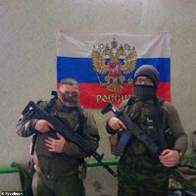 Stimson (left) has been photographed on the front line wearing Russian uniforms and posing in front of a Russian flag.