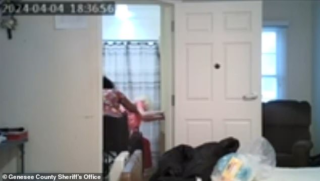 Footage shows Arrington repeatedly tearing a full diaper over the victim's head as she sits helplessly in her wheelchair and raises her arms in defense.