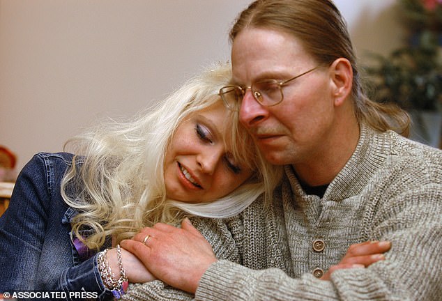 The former hostage, now 41, has since claimed that her father Jerry Kach (pictured together above) does not believe her account that she remained under Hose's control.