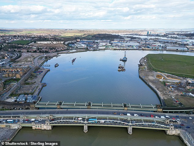 In Rochester, the train crosses the River Medway, where a Cold War-era Soviet submarine called the Black Widow is moored (above left)