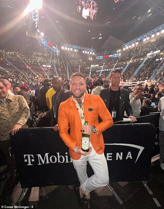 McGregor was also seen posing front row with a bottle of his 'Proper No 12' whiskey.