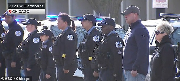 Fellow police officers and firefighters were seen saluting the American flag that was raised in the middle of the street in honor of Huesca.