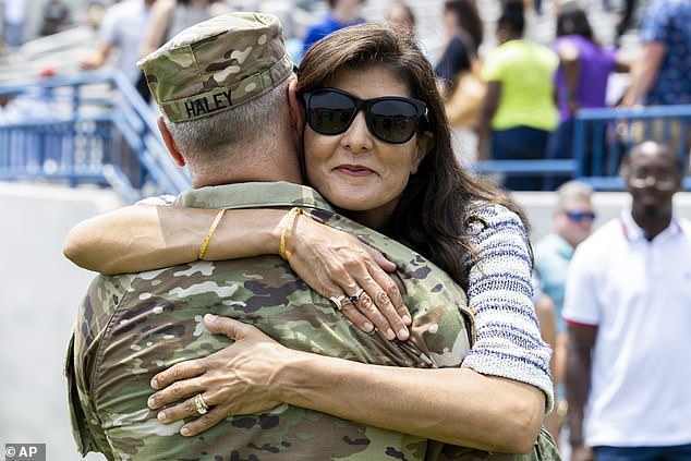 Republican presidential candidate Nikki Haley hugs her husband, Maj. Michael Haley, after a deployment of his unit.