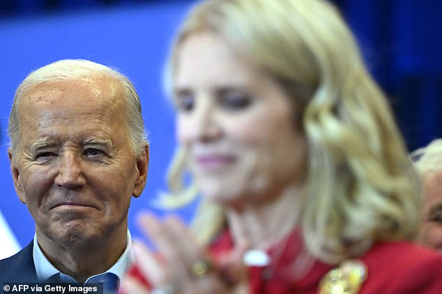 US President Joe Biden listens to Kerry Kennedy (R) as she and members of the Kennedy family endorse his presidential campaign.