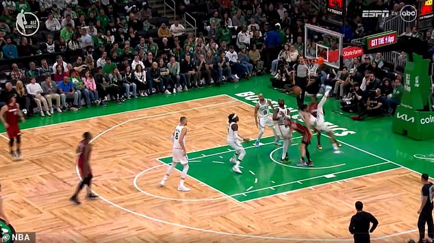 The Heat forward crashed into the paint to grab a rebound while Tatum was facing the rim.