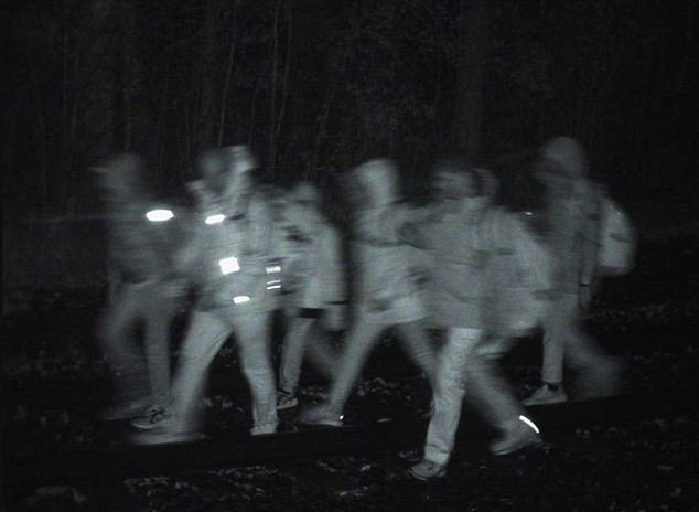 Border Patrol images show a group of people crossing the border from Canada into the US.