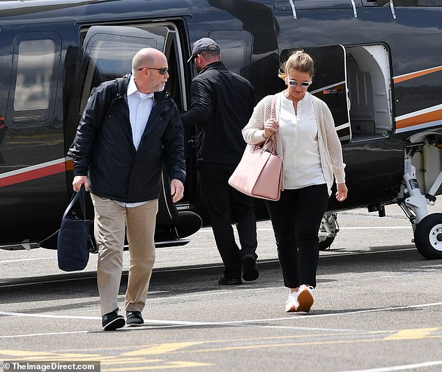 An assistant could be seen carrying a navy blue bag while Melinda carried her own pink bag.