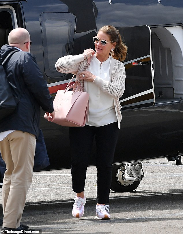 Melinda carried a pink Chanel bag and was wearing a mesh jacket, white blouse, black pants and Loewe sneakers.