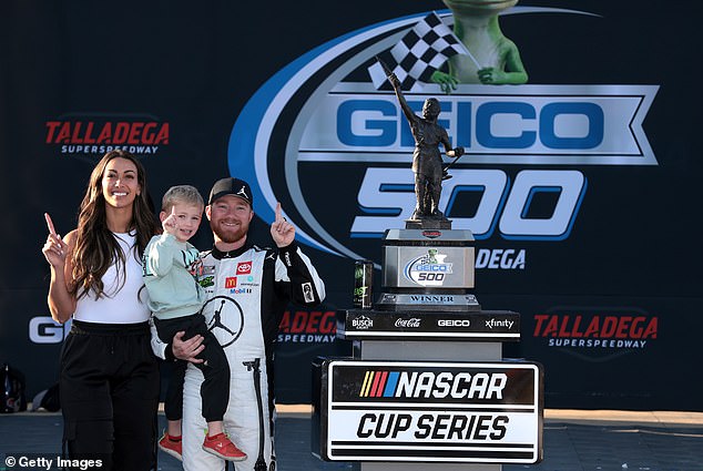 Reddick, his wife, Alexa De Leon, and their four-year-old son, Beau, posing in victory lane.