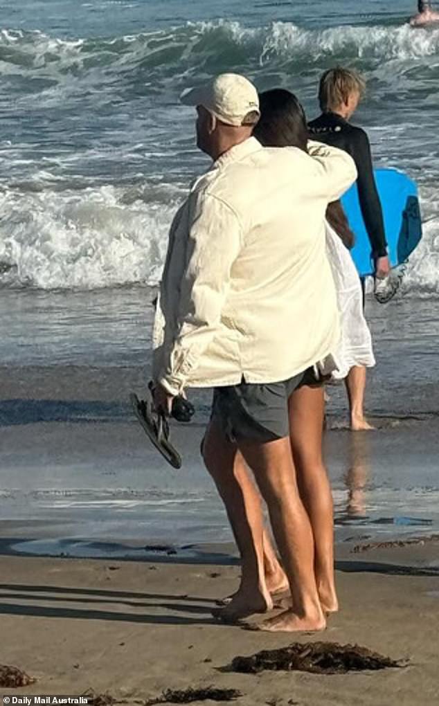 In photos taken by an eagle-eyed fan, the couple looked very happy as they walked hand in hand on the sand and looked out to sea.