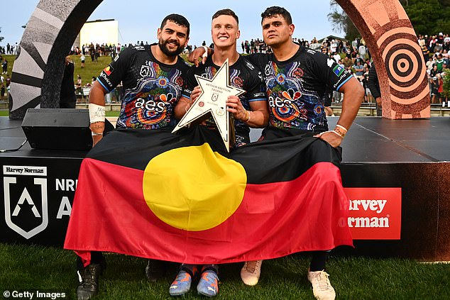 Shaq Mitchell (left) with his brother Latrell (right) and Souths teammate Jack Wighton, pictured alongside the Indigenous All Stars in 2023.