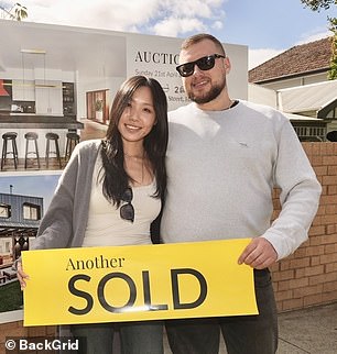 They were all smiles as they posed with the sold sign.