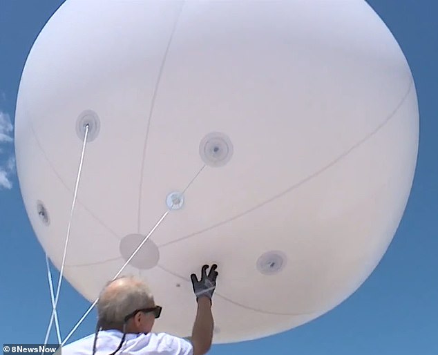 About 15 other community members joined the resident as he released the balloon.