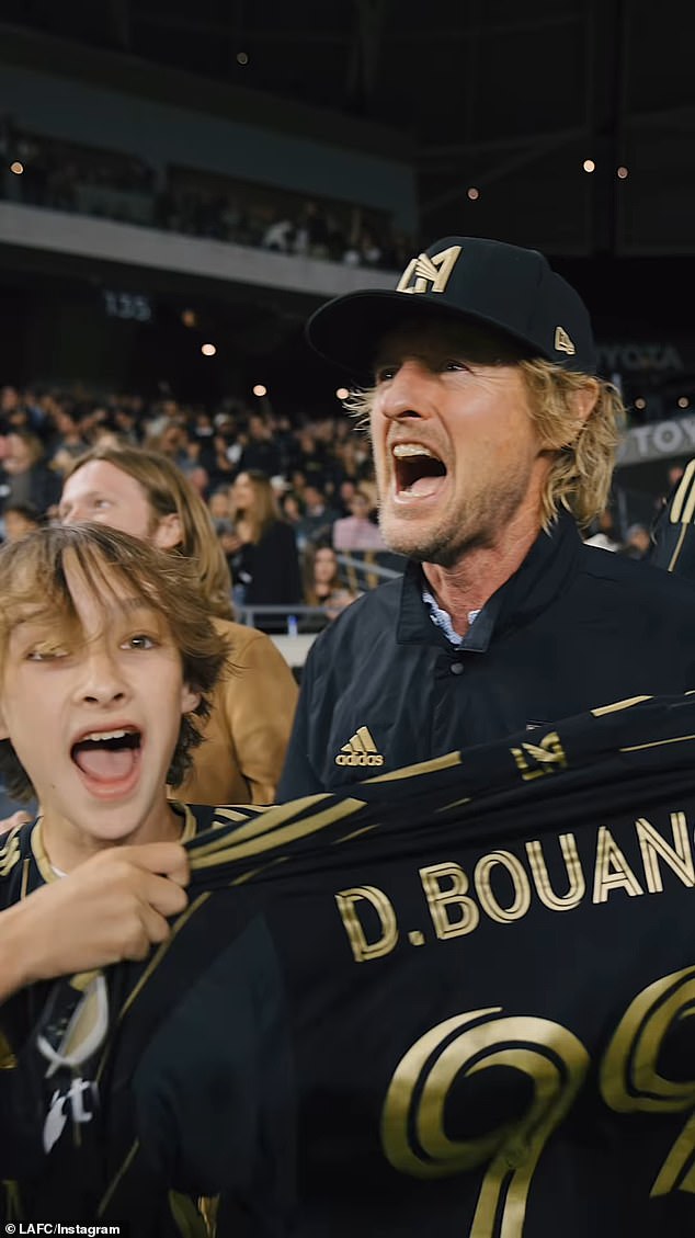 Wilson and his children were seen celebrating LAFC striker Denis Bouanga's soccer jersey with the number 99 in his hand.