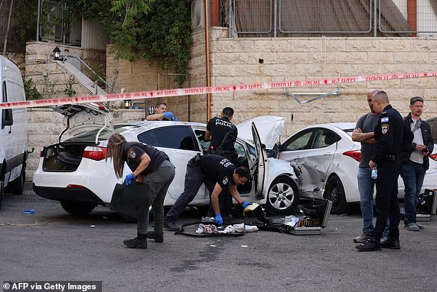 Israeli police are seen investigating the scene of the attack after the alleged 