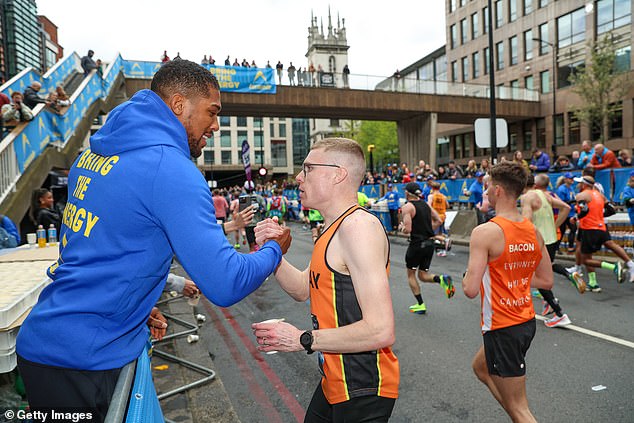 The British boxer shared a touching moment with a runner who had been struggling