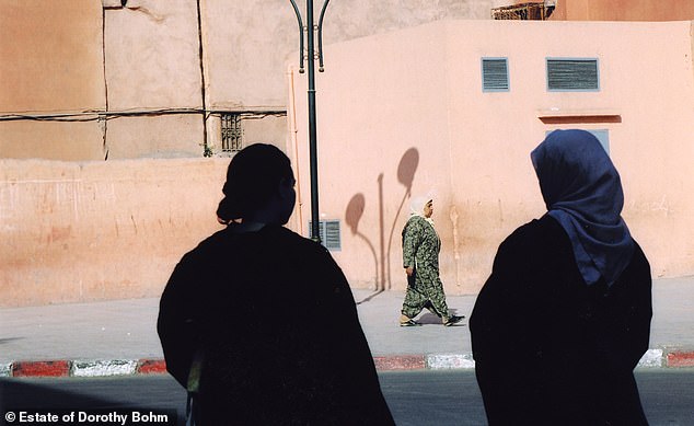 Bohm continued taking photographs throughout Europe in his old age. Above: Locals on a street in Marrakech, Morocco, in 2004.