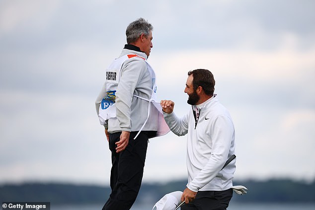 Scheffler celebrates with caddy Ted Scott, who has won more than many players in 2024