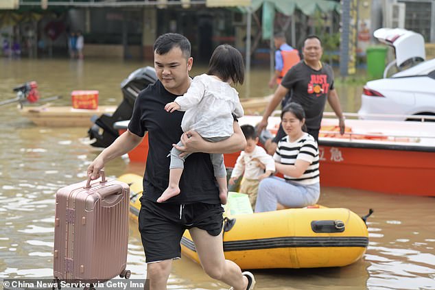 Residents were seen carrying suitcases and removing children from small rubber boats as they tried to find safety in the deep waters.