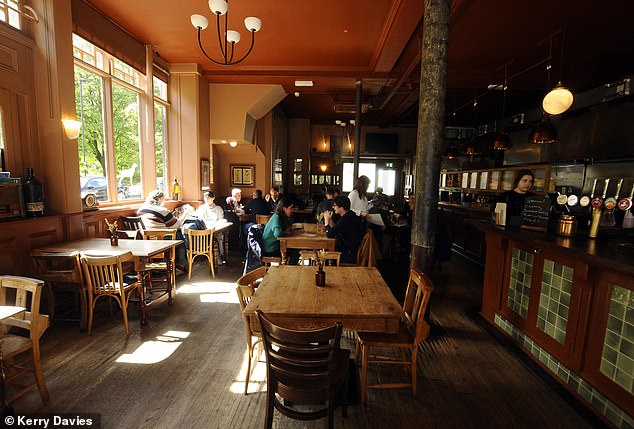 The Black Dog has a charming Victorian-style interior with wood paneling, green tiles and antique chandeliers.