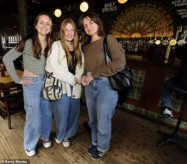 Taylor Swift fans Jordan Ludwig (right), 20, Kylee Ludwig (left), 20, and Katelyn Anziano (center), 20, inside the Black Dog on the day of the song's release.