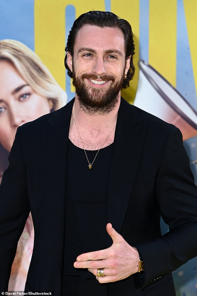 Aaron looked in high spirits at the film screening as he posed in his dapper suit and gold jewelry.