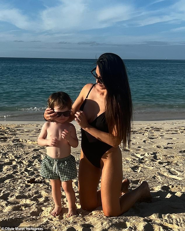 Munn is seen here in a swimsuit with her son she shares with her partner John Mulaney.