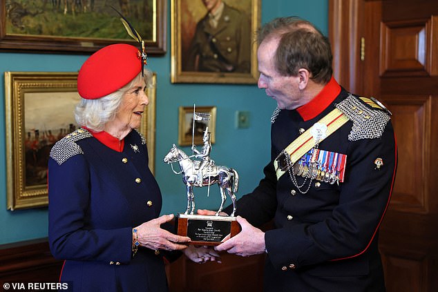 Colonel Richard Charrington presented Britain's Queen Camilla with a trophy celebrating her visit to The Royal Lancers.