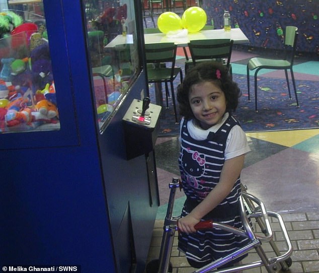 As her graduation day approached, Malika said she almost backed out of her plan and took her wheelchair up to the stage. (pictured: Malika holding on to a walker in a game room)