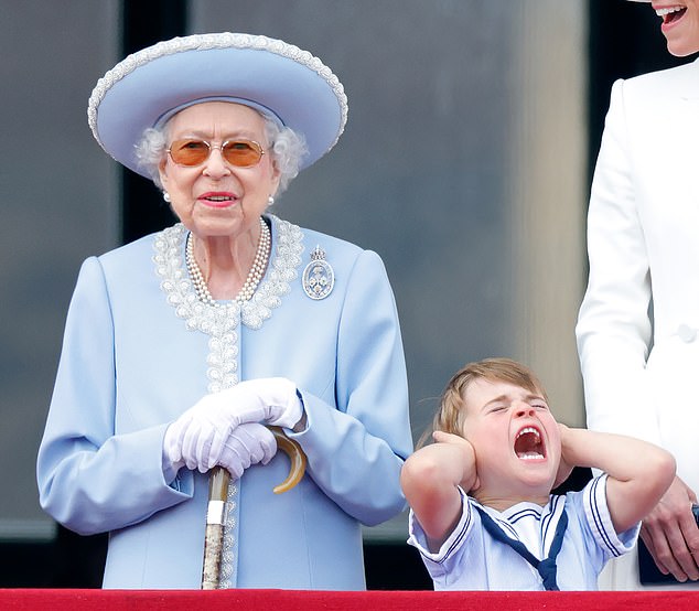 The Queen, usually a stickler for good behavior, seemed oblivious to the presence of her adorable great-grandson.  Or maybe she just found it funny...