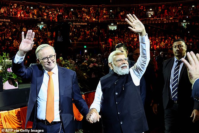 Prime Minister Anthony Albanese (pictured left) hugged and held hands with Indian Prime Minister Narendra Modi (pictured right).