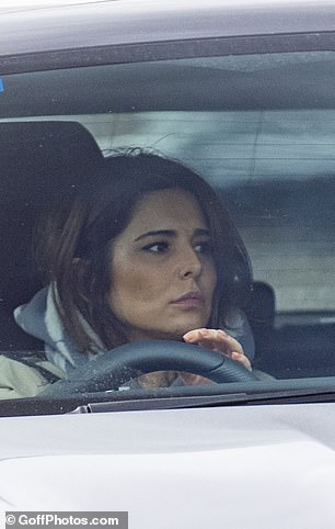Appearing behind the wheel, Cheryl appeared to be focused as she was stuck in traffic while wrapped in a coat.
