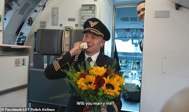 The pilot brought out a large bouquet of flowers before getting down on one knee and asking if Paula would marry him.
