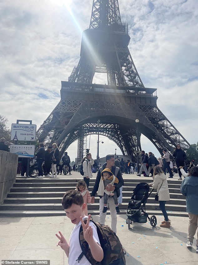 Brody, 11 years old, photographed at the Eiffel Tower.  His mother spent £55 each on return flights and the family enjoyed a day of sightseeing.