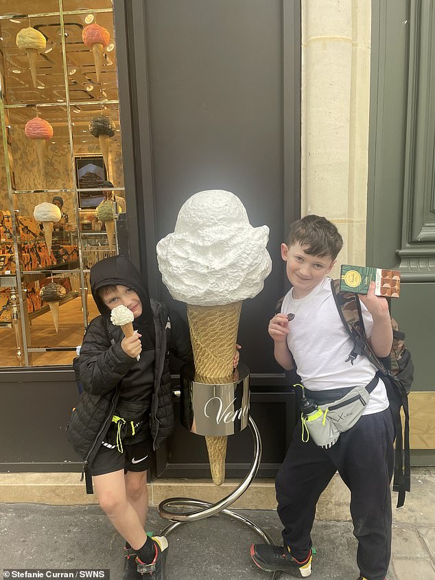 The two children looked cheerful as they were photographed next to an ice cream cone with a chocolate treat.