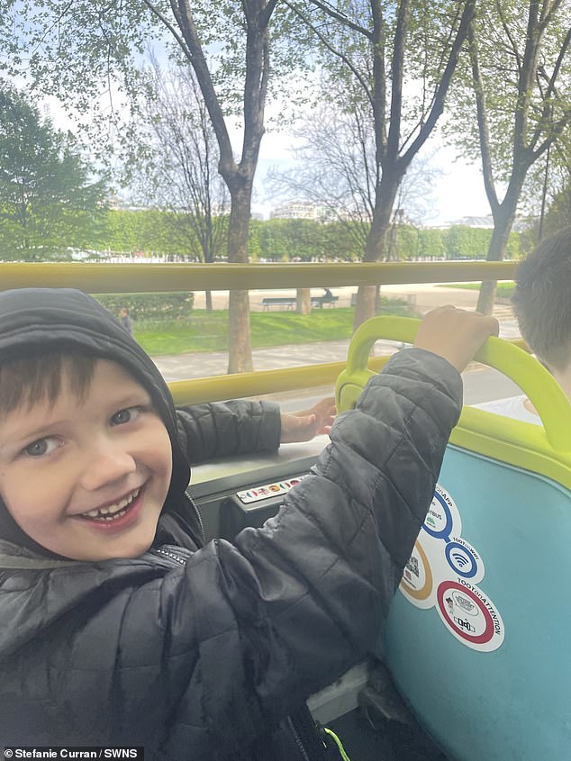 Romeo, 7 years old, enjoying the views of Paris from an open-top bus.  The family traveled around the city on the Tootbus tour bus for a combined price of €83.